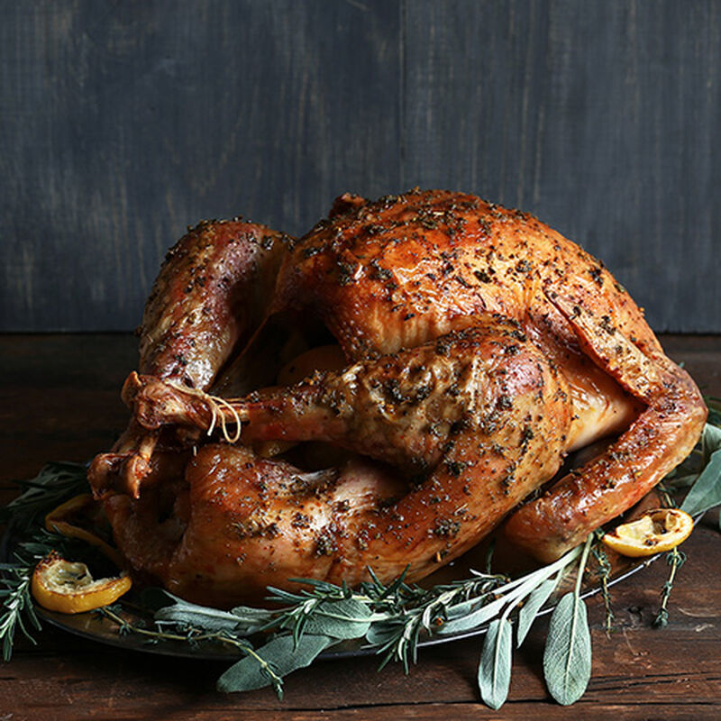 Roasted turkey on a bed of herbs and veggies