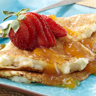 Cream Cheese Filled Crepes with Mango Peach Sauce