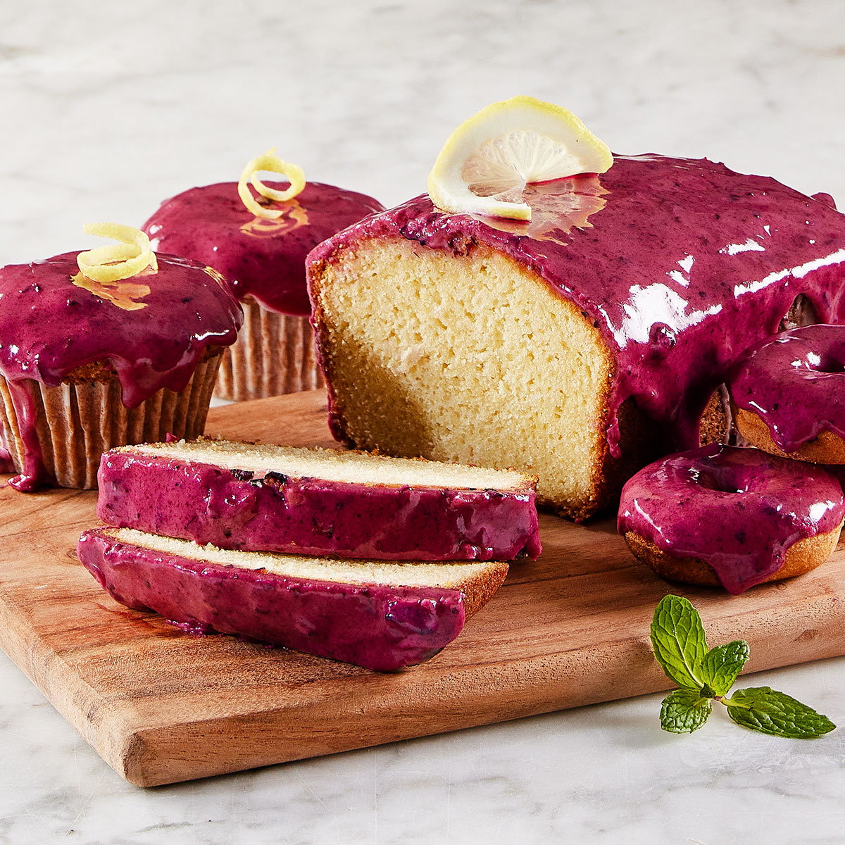 image of multiple baked goods covered in a blueberry glaze