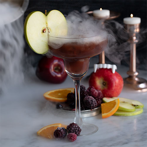 image of three glasses of purplish red blueberry mojito mocktails each with little blueberry and lime garnishes on a light blue napkin