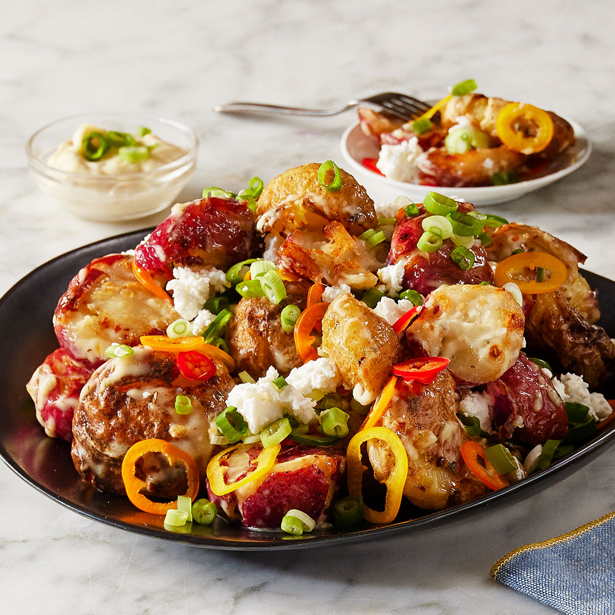 image of a plate of crispy potato salad on a marble countertop